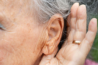 Person cupping ear